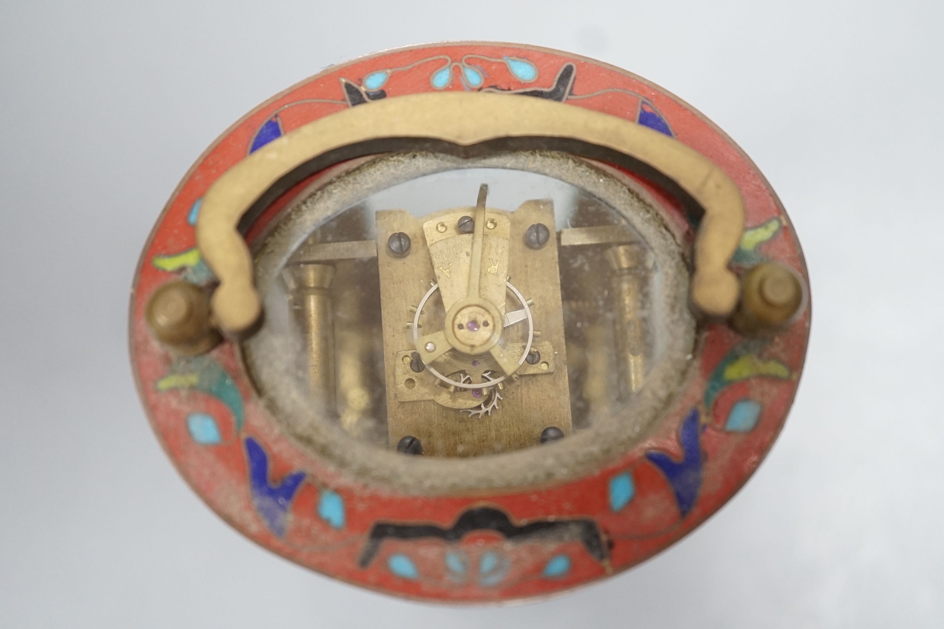 A mignonette oval brass and champleve enamelled timepiece 9cm